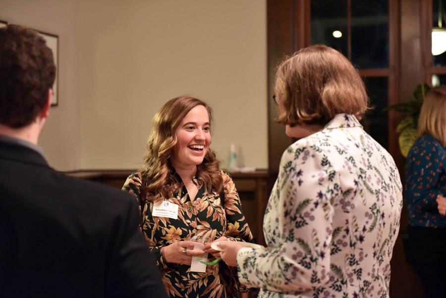 a member of the alumni leadership board smiles while talking to a senior