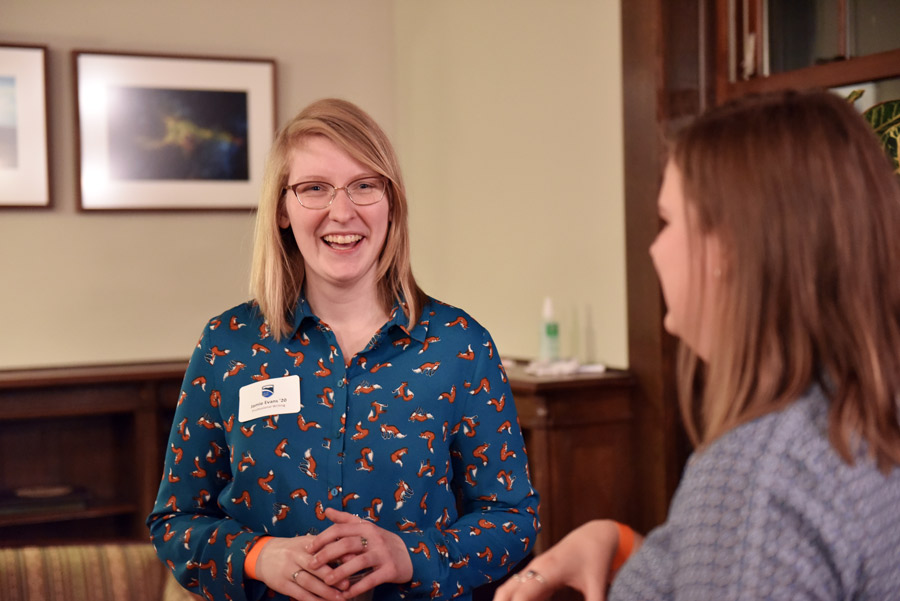 smiling graduate at a champlain connect event