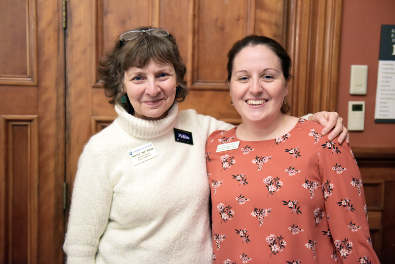 a smiling career coach and advancement employee pose for the camera at a champlain connect event