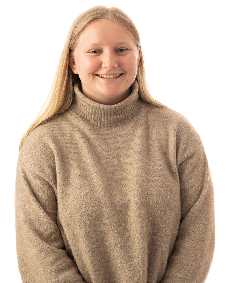 headshot of Olivia Sommerer smiling in a tan turtleneck sweater